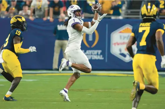  ?? RICK SCUTERI/AP ?? TCU wide receiver Quentin Johnston makes one of his six catches for 163 yards during Saturday’s Fiesta Bowl victory against Michigan.