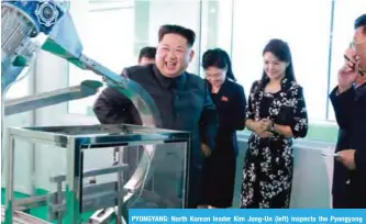  ?? — AFP ?? PYONGYANG: North Korean leader Kim Jong-Un (left) inspects the Pyongyang Cosmetics Factory, as his wife Ri Sol-Ju (2nd right) looks on.