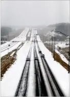  ?? ALLISON CARTER / THE TIMESDAILY ?? Snow covers a majority of a road Tuesday in Florence, Ala. Gov. Kay Ivey declared a state of emergency. Numerous businesses and government offices closed because of the weather.