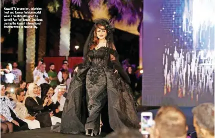  ??  ?? Kuwaiti TV presenter , television host and former fashion model wear a creation designed by Lamsit Fan “art touch” boutique, during the Kuwait internatio­nal fashion week in Kuwait City.