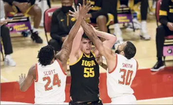  ?? Nick Wass / Associated Press ?? Iowa center Luka Garza, center, was 9-for-14 from the field in Thursday’s win over Maryland.