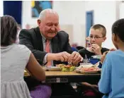  ?? Carolyn Kaster / Associated Press ?? Agricultur­e Secretary Sonny Perdue eats lunch with pupils in Leesburg, Va., where he announced the loosening of health guidelines for school meals.