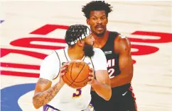  ?? KIM KLEMENT / USA TODAY SPORTS ?? The one- on- one battles between Lakers forward Anthony Davis, front, and Heat forward Jimmy Butler have been
among the treats of the bubble Finals.