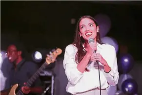  ?? — AFP ?? Women power: Ocasio- Cortez speaking to a crowd at a night club in Queens, New York City, a day before the election.