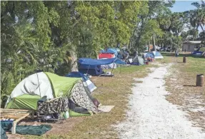  ?? LANNIS WATERS/PALM BEACH POST ?? Tents just south of Sixth Avenue South in Tent City, a homeless encampment at John Prince Park west of Lake Worth Beach.