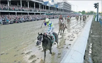  ?? J. PHILLIP/THE ASSOCIATED PRESS] [DAVID ?? John Velazquez rides Always Dreaming to a 2 -length victory over Lookin at Lee at soggy Churchill Downs.