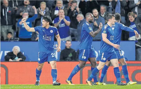  ?? REUTERS ?? Leicester City’s Shinji Okazaki, left, celebrates scoring their first goal with teammates.