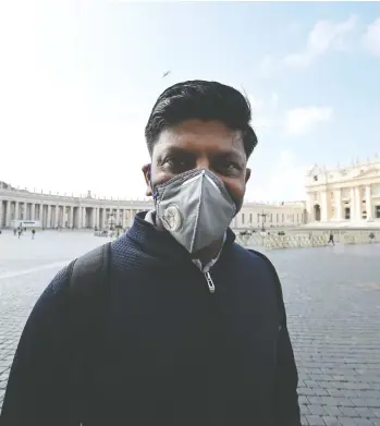  ?? INCENZO PINTO / AFP VIA GETTY IMAGES ?? A man wearing a protective mask walks past a deserted St. Peter’s Square in the Vatican, which reported its first
coronaviru­s case on Friday. Italy has by far the most cases in Europe, with 769 new cases confirmed on Friday.