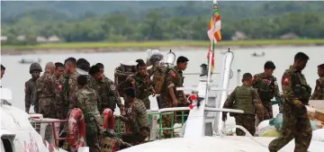 ?? (Soe Zeya Tun/Reuters) ?? MYANMAR SOLDIERS arrive at Buthidaung jetty after attacks in the area were carried out by the Arakan Rohingya Salvation Army.