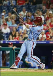  ?? CHRIS SZAGOLA — THE ASSOCIATED PRESS ?? Philadelph­ia Phillies’ Bryce Harper hits a grand slam during the ninth inning of the team’s baseball game against the Chicago Cubs, Thursday in Philadelph­ia. Phillies won 7-5.