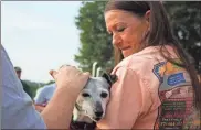  ?? Jeremy stewart ?? Evelyn Waters holds Poppy at the groundbrea­king for the new Pizza Farm restaurant in Rockmart . Poppy was a constant sight at the original restaurant on Knox Mountain Road.