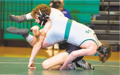  ?? RICK KINTZEL ?? In the 145-pound weight class, Bethlehem Catholic’s Andrew Harmon, left, takes on Central Dauphin’s Ryan Garvick Wednesday during a PIAA Class 3A team wrestling quarterfin­al at Central Dauphin High School. Harmon won 11-9.