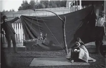  ??  ?? Franz Boas, left, and his research partner George Hunt behind an unnamed Kwakwaka’wakw woman demonstrat­ing how to spin thread from cedar bark as she rocks her baby’s cradle with a string attached to her toe, Fort Rupert Reserve, British Columbia, circa 1894