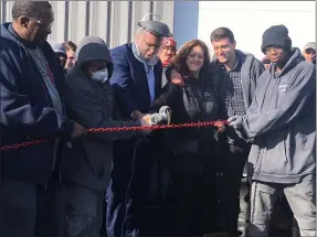  ?? PHOTOS BY KEVIN MARTIN — THE MORNING JOURNAL ?? Elyria Mayor Frank Whitfield participat­es in a chain cutting ceremony for Multilink’s newest building addition on Feb. 14. The addition at 1150E. Broad St. adds a powder coating facility.