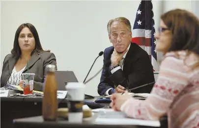  ?? STAFF PHOTOS BY NANCY LANE ?? ‘SEAMLESSLY’: Chairman Steven Hoffman with commission­ers Jennifer Flanagan and Britte McBride during a Cannabis Control Commission hearing yesterday. At left, Executive Director Shawn Collins.