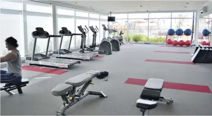  ??  ?? Amenities at Onze de la Gare in Vaudreuil-Dorion include a fully-equipped gym, a heated saltwater outdoor pool, and a fully-equipped reception room for special events.