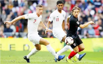  ??  ?? England’s Ross Barkley (left) and Marcus Rashford in action with Croatia’s Luka Modric. — Reuters photo