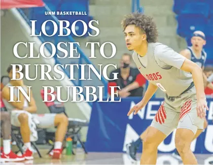  ?? UNM ATHLETICS ?? Lobos guard Isaiah Marin was one of four freshmen who had significan­t playing time Friday against Utah State in Lubbock, Texas. The Lobos were blown out 82-46 as the strain of being isolated out of state and locked down during the pandemic is taking its toll.