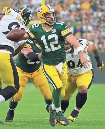  ?? USA TODAY-WISCONSIN ?? Aaron Rodgers looks for an open receiver as he exits the pocket during the first quarter.