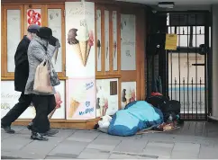  ?? STEVE PARSONS / PA VIA THE ASSOCIATED PRESS ?? A homeless person sleeps in a doorway near Windsor Castle on Thursday.