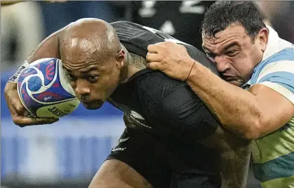  ?? CHRISTOPHE ENA/AP ?? New Zealand’s Mark Telea (left) is grappled by Argentina’s Agustin Creevy during the Rugby World Cup semifinal outside Paris on Oct 20. The All Blacks triumphed in that one, 44-6. Now, against the Springboks, they face the ultimate rivalry.