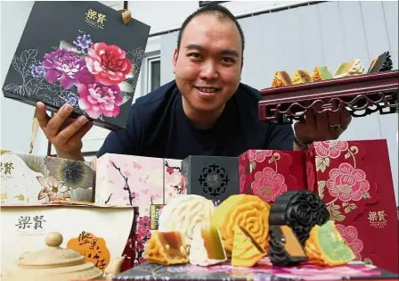  ??  ?? Leong showing the mooncakes at his shop in Patani Road. Seasonal favourite: