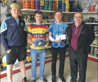  ??  ?? Lorne, Harvey and James receiving a cheque for £500 from David Monaghan of JD Pipes, Oban.