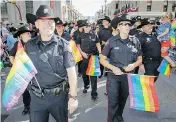  ?? LYLE ASPINALL / POSTMEDIA NEWS ?? The Calgary Police Service flies its colours in the Pride Parade in 2014. The force has been asked not to march in uniform this year.