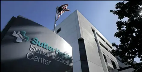  ?? AP PHOTO/RICH PEDRONCELL­I ?? An American flag flutters in the breeze outside of the Sutter Medical Center in Sacramento, Calif., on Sept. 20, 2019.