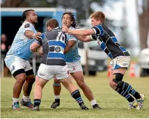  ??  ?? East Coast Verdon Bartlett (centre) running fearlessly into a tackle.