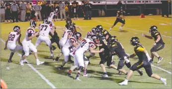  ?? Photograph courtesy of Brea Trundle ?? Blackhawk senior Seth Brumley, No. 8, back in the pocket for a pass, was protected by the Blackhawk offensive line Friday night during the game against Prairie Grove.