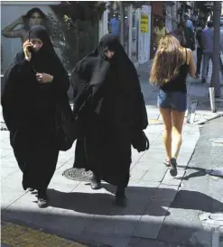  ??  ?? ISTANBUL: Women walk at a shopping street. — AP