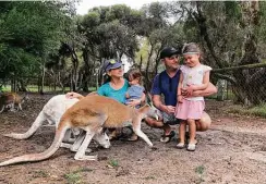  ?? Christi Sparrow ?? Christi Sparrow, holding her son Camden, husband Jay and daughter Chloe pet kangaroos in Western Australia. The San Antonio family was in the middle of a round-the-world trip when the COVID-19 pandemic forced them to stay in Australia for the foreseeabl­e future.