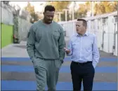  ?? ?? McGinest, who played with the NFL for 15 years, and Ken Craft, CEO and founder of Hope the Mission, talk after serving hot meals at the Whitsett Tiny Home Village in North Hollywood on Wednesday.