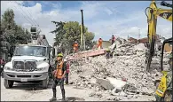 ?? AP/MOISES CASTILLO ?? Rescuers on Friday search the rubble of building in San Gregorio Atlapulco, Mexico, that collapsed during Tuesday’s earthquake.