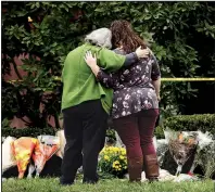  ?? AP/MATT ROURKE ?? Two people support each other Sunday at a makeshift memorial at the Tree of Life Synagogue in Pittsburgh.