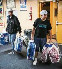  ??  ?? Donations poured in at the temple as word spread that it had opened its doors to all evacuees.