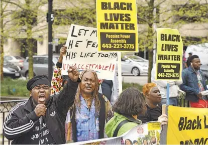  ?? AMY DAVIS/BALTIMORE SUN ?? The Rev. Cortly “C.D.” Witherspoo­n, left, president of the Baltimore chapter of the Southern Christian Leadership Conference, speaks Monday at a demonstrat­ion outside City Hall as protesters demand answers about the death of Freddie Gray.