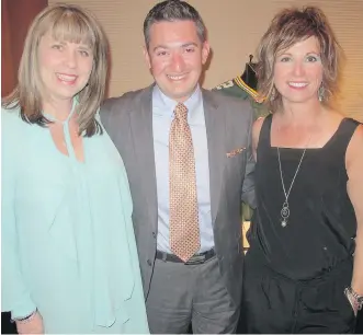  ?? PHOTOS: BILL BROOKS ?? The sixth annual Up &amp; Away Charity Gala held May 7 in the Palomino Room raised 30 per cent more than last year’s gala. No small feat in these challengin­g economic times. Pictured at the gala, from left, are volunteer Carrie Grant, UP board chair Tony Ciarla and UP CEO Patricia Jones.