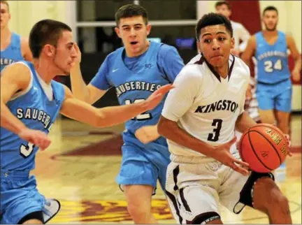  ?? TANIA BARRICKLO — DAILY FREEMAN ?? Kingston’s Chris Wright drives past Saugerties’ Austin Curlin during Tigers’ victory over Sawyers.