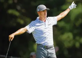  ??  ?? Collin Morikawa blasts from the bunker to the 18th green on his way to a birdie to finish at 12 under par during the third round of the Tour Championsh­ip.
Justin Thomas reacts to hooking his drive off the fifth tee during the third round on Sunday.