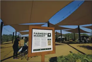  ??  ?? Several local vendors set up their booths at Spaces of Opportunit­y in south Phoenix for its weekly farmers market Tuesday, Oct. 17. Arizona nonprofits have joined other groups around the U.S. working to bring fresh produce and healthy food options to residents in low-income and racially and ethnically diverse neighborho­ods. Spaces of Opportunit­y, a collective of Phoenix-based organizati­ons, was founded on the idea the community could come together to grow local fruits and vegetables, assist local farmers with land and income, and educate its residents about food security.