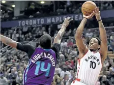  ?? FRANK GUNN/THE CANADIAN PRESS ?? Toronto Raptors guard DeMar DeRozan makes a shot as Charlotte Hornets forward Michael Kidd-Gilchrist attempts to defend during first half NBA basketball action, in Toronto on Wednesday.