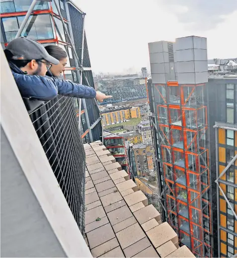  ?? ?? Tate Modern visitors on the viewing platform of the Switch House can look into the glass-walled flats of the Neo Bankside building, leaving residents feeling observed. Left, a ground view shows the proximity