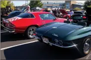  ?? NWA Democrat-Gazette/CHARLIE KAIJO ?? Jim Graves of Clarksvill­e details his ’76 Chevrolet Camaro parked Saturday next to a ’65 Chevrolet Corvette at the Arvest Ballpark in Springdale. He has entered his car into the car show three times. “They’re never really finished,” he said of the...