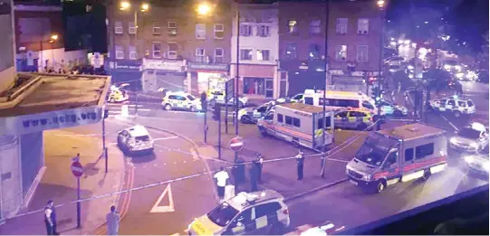  ??  ?? Police vehicles surround a crime scene after a vehicle hit pedestrian­s in London on Monday. (AFP)