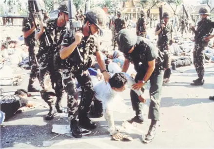  ?? BANGKOK POST ?? Soldiers arrest a demonstrat­or at the height of Black May uprising on May 19, 1992. The protests were staged against post-coup prime minister Suchinda Kraprayoon, who was not elected to the position.