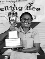  ?? PHOTOS BY IAN ALLEN/ PHOTOGRAPH­ER ?? Olga Williams, representi­ng the parish of St Mary, proudly holds her trophy after winning the National Council for Senior Citizens, National Spelling Bee Competitio­n for 2022.