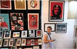  ?? ?? A woman looks at artworks at La Fabrica de Arte Cubano (The Cuban Art Factory) in Havana.—AFP photos