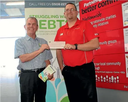  ??  ?? Eugene Williams of CAP New Plymouth, left, receives a $1000 cheque from the manager of the New Plymouth Warehouse, Robert Larsen.